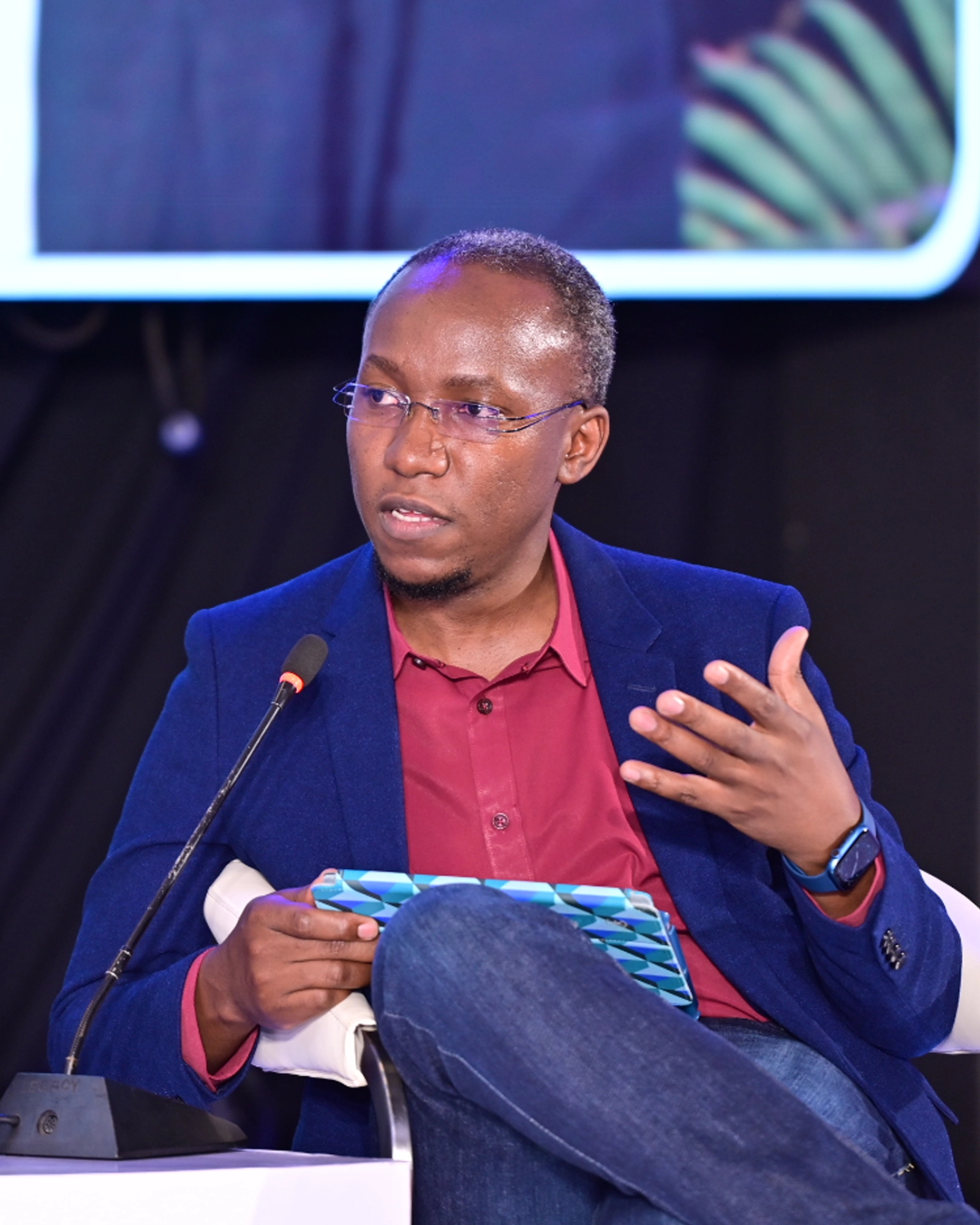 John Ssenkeezi speaking at a conference